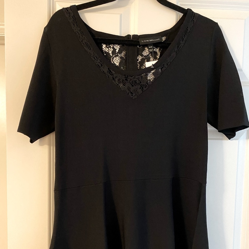 Black top with lace trim and zipper back.
